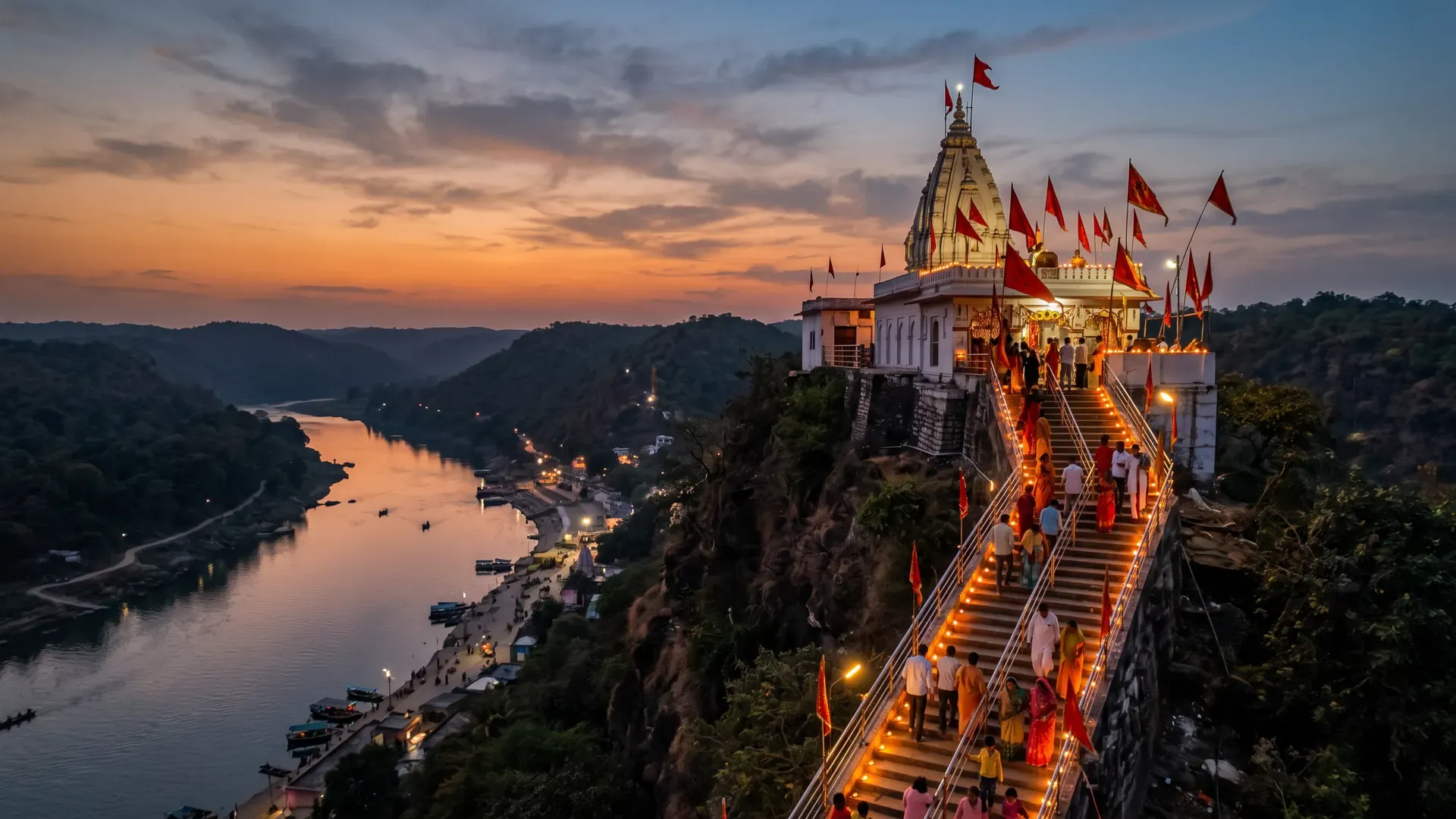 A hilltop Devi temple with flags above the Ganga at dusk, its steps lit with lamps